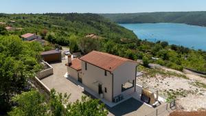 an image of a house with a view of a lake at Vila Laguna Blu by Villas Guide in Trget