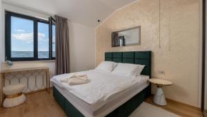 a bedroom with a large bed and a window at Vila Laguna Blu by Villas Guide in Trget +31 photos