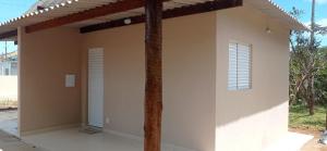 a building with a porch with two windows at Casa Studio Uirá - rua dos Cravos in Chapada dos Guimarães