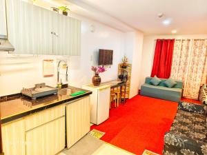 a kitchen and living room with a red rug at 2B-03 Condo Staycation at Megatower 1 in Baguio