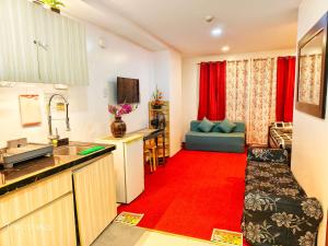 a kitchen and living room with a red carpet at 2B-03 Condo Staycation at Megatower 1 in Baguio +22 photos