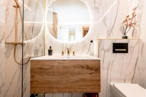 a bathroom with a sink and a mirror at Sunset Stay Pärnu in Pärnu
