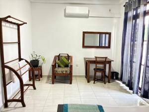 a living room with a table and a mirror at Amani Rooms in Panadura