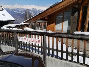 a house with a balcony with snow on it at Cozy Apartment With Mountain Views in Veysonnaz +40 photos