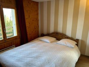 a bedroom with a bed with two pillows on it at Pet-friendly chalet in Veysonnaz in Veysonnaz