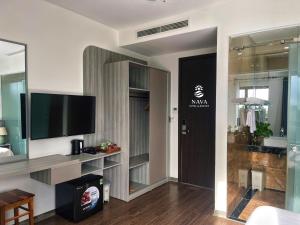 a living room with a flat screen tv on a wall at Nava Hotel & Resort in Dong Hoi
