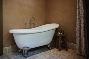 a white bath tub in a bathroom with a shower at Blacksmith House on Main in Tocumwal +12 photos