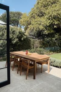 a wooden table and bench sitting on a patio at Blacksmith House on Main in Tocumwal