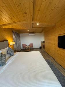 a large bed in a room with a wooden ceiling at OREN Kasauli in Kasauli