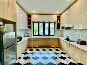 a kitchen with a checkered floor at Villa Alam Klang managed by Bella Vista Hotels & Resorts in Klang