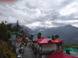 an overhead view of a town with mountains in the background at ONLY CAFE Hotel in Chopta +13 photos