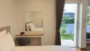 a bedroom with a mirror and a bed at HomeGate Resort in Prachuap Khiri Khan +26 photos
