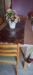 a table with a vase of flowers on top of it at CLAUDIA Blessings in Saint Gabriel +5 photos