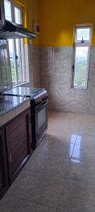a kitchen with a stove and a counter top at CLAUDIA Blessings in Saint Gabriel