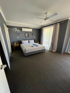 a bedroom with a bed and a large window at Hibiscus Haven in Eaton