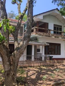 a house with a tree in front of it at flying in stay in Dankotuwa