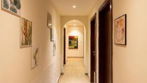 a hallway with paintings on the walls of a house at Devine Holidays JBR in Dubai +1 photo