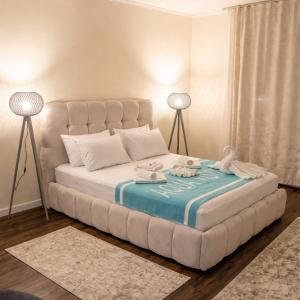 a large white bed in a room with two lamps at Villa Aqua Vista in Mostar +33 photos