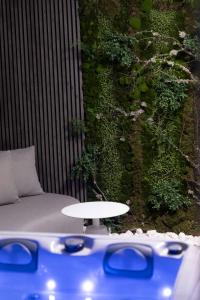 a living wall with a table in front of a couch at Edem in Larisa