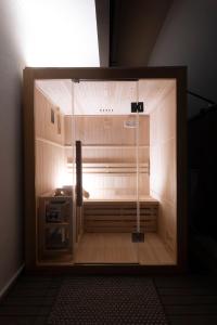 a large wooden enclosure with a light inside of it at Edem in Larisa