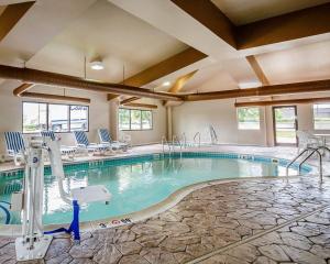 a pool in a hotel with blue chairs at Comfort Suites Louisville East in Douglass Hills