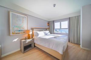 a hotel room with a bed and a window at Hilton Mallorca Galatzo in Paguera