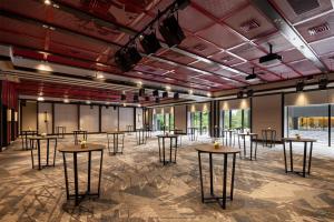 a large room with tables and chairs in it at Fuji Speedway Hotel, in The Unbound Collection by Hyatt in Oyama