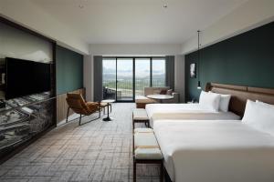 a hotel room with two beds and a tv at Fuji Speedway Hotel, in The Unbound Collection by Hyatt in Oyama +263 photos