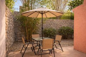 a table and chairs with an umbrella on a patio at Casa Real in Manuel F. Martínez