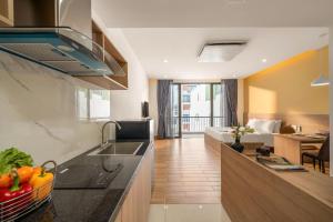 a kitchen with a sink and a counter top at Mai Living Apartment in Danang