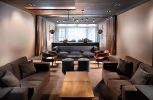 a living room with couches and a couch and chairs at Hotel Savoy Kansas City, Tapestry Collection by Hilton in Kansas City