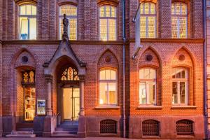 a brick building with many windows and a door at Hopper Hotel St. Josef, WorldHotels Crafted in Cologne