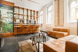 a living room with a couch and a table at Hopper Hotel St. Josef, WorldHotels Crafted in Cologne +55 photos