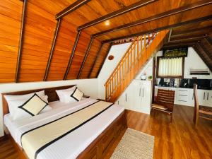 a bedroom with a large bed and a kitchen at Cinnamon Crown in Matara
