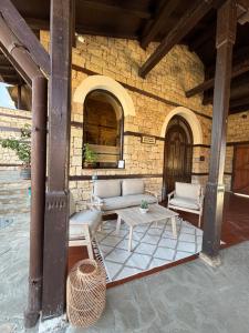 a patio with chairs and a table and a building at A&N Residence Bolyarka in Arbanasi