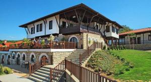 a large house with a balcony on top of it at A&N Residence Bolyarka in Arbanasi