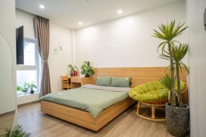 a bedroom with a bed and a chair at Dahill 196 Dalat in Da Lat