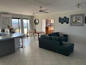 a living room with a couch and a table at Hibiscus Haven in Eaton