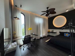 a bedroom with a bed and a ceiling fan at Nhật Quang House 2 in Danang