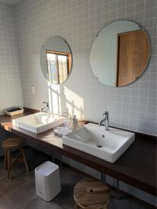 a bathroom with two sinks and a large mirror at 宿杏 Yado Ann in Kofu