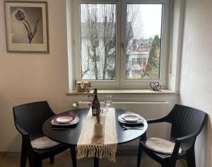 a dining room table with two chairs and a window at Allgäu Space in Marktoberdorf