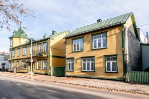 a wooden building on the side of a street at Sunset Stay Pärnu in Pärnu
