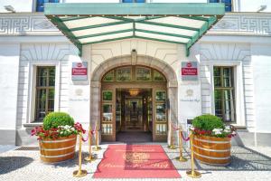 a front door of a building with flowers in front at Best Western Premier Grand Hotel Russischer Hof in Weimar