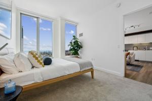 a bedroom with a large bed and large windows at Spera in San Francisco