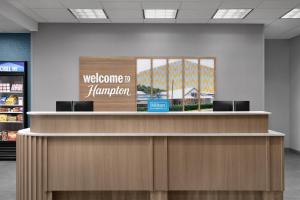 a welcome counter in a store with a welcome to hammber sign at Hampton Inn & Suites Roswell in Roswell
