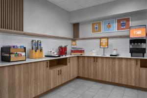 a kitchen with wooden cabinets and a counter top at Hampton Inn & Suites Roswell in Roswell