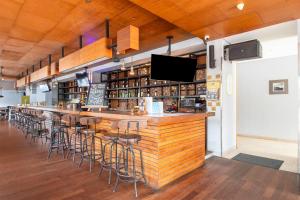 a bar in a restaurant with stools at a counter at Palette Legian Beach in Legian