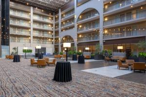 an empty lobby of a building with chairs and tables at Embassy Suites by Hilton Seattle Bellevue in Bellevue