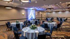 a banquet room with tables and chairs with flowers on them at Embassy Suites by Hilton Seattle Bellevue in Bellevue +69 photos