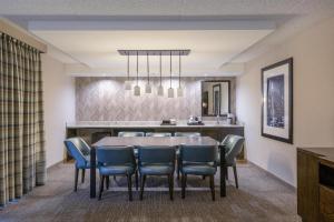 a dining room with a table and chairs at Embassy Suites by Hilton Seattle Bellevue in Bellevue